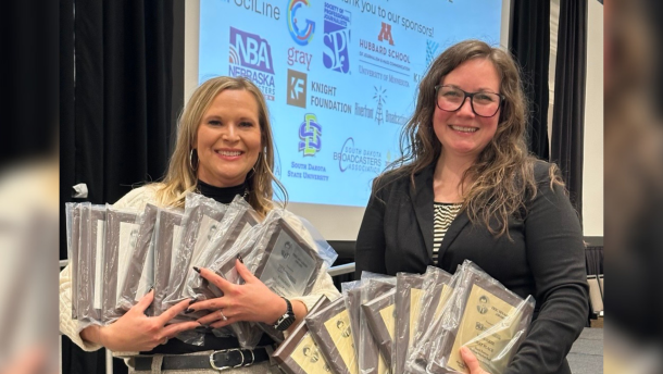 CEO/General Manager Sarah Bignall and News Director Chelsey Perkins hold the 18 Eric Sevareid Awards earned by the KAXE News team at the Midwest Broadcast Journalism Association's 2026 awards banquet April 11, 2026, at the InterContinental St. Paul Riverfront hotel.