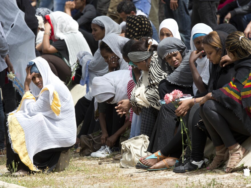 Women grieve as the coffin of one of the 24 migrants who drowned while trying to reach Italy, is buried in Santa Maria Addolorata Cemetery on the outskirts of Valletta, Malta, on April 23, 2015. The migrants died as a smuggler's boat crammed with hundreds of people overturned off the coast of Libya.