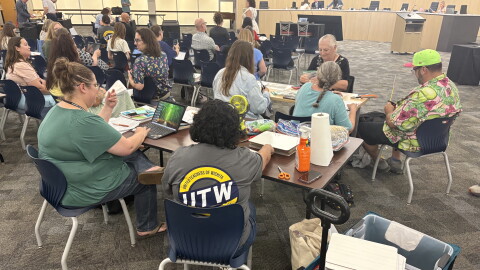 The Wichita teachers union conducted a sit-in demonstration at the Wichita Board of Education meeting on Monday, inviting teachers to bring work they usually do at home to complete during the meeting.
