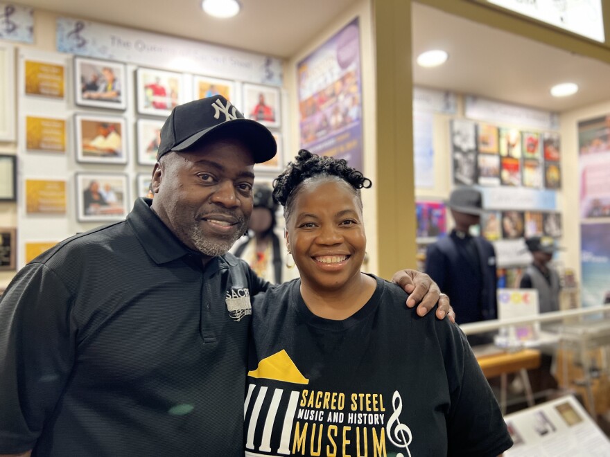 Del Ray and Kelli Grace stand in front of an exhibit at the Sacred Steel Music and History Museum in Toledo.