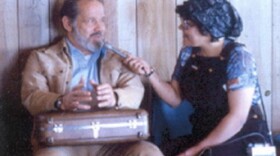 a woman interviews a man with a microphone