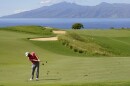 FILE- Jon Rahm, of Spain, hits from the 13th fairway during the final round of the Tournament of Champions golf event, Sunday, Jan. 9, 2022, at Kapalua Plantation Course in Kapalua, Hawaiʻi.