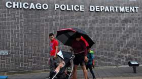 CHICAGO, IL - SEPTEMBER 11: Venezuelan migrants Yorbis Natera (red tee) and Ismar Aular (pushing stroller), left, who are living at the Chicago Police Department's 15th District walk their kids to school on Monday, September 11, 2023 in Chicago, Illinois. Since last year, over 14,000 migrants, mostly from Venezuela, have arrived in Chicago by bus from the Texas border. Chicago, which is a sanctuary city has been housing the asylum seekers at police stations, O'Hare International Airport, and city-run shelters.  (Photo by Joshua Lott/The Washington Post via Getty Images)