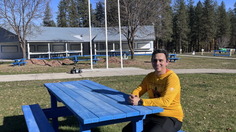 Danny Brigman sitting outside at the Wellpinit Powwow Grounds.