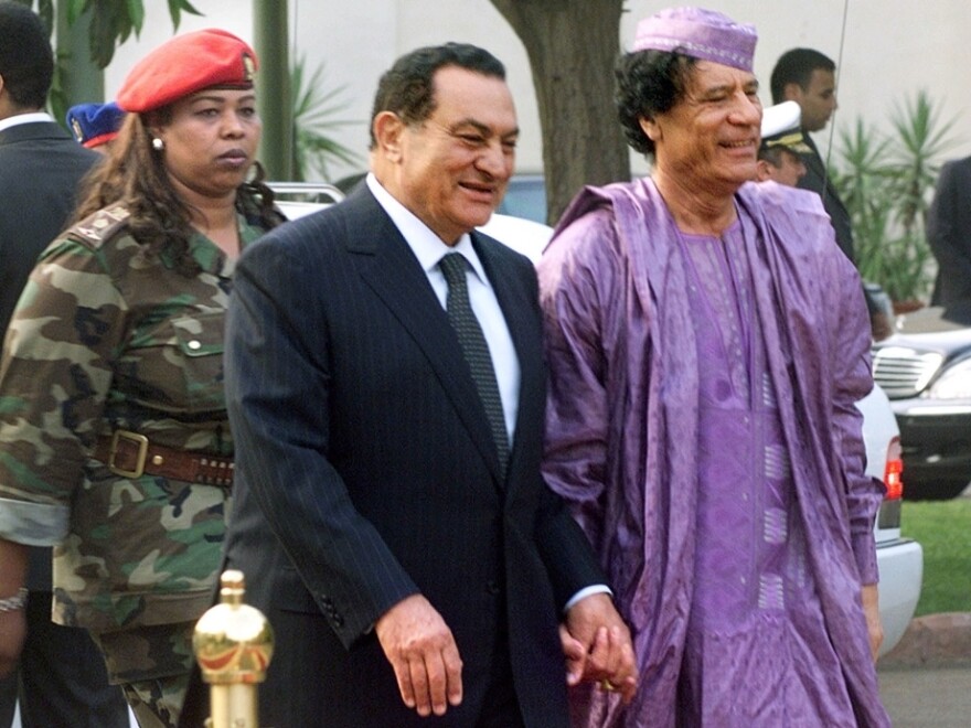 Libyan leader Moammar Gadhafi (right) is welcomed by then-Egyptian President Hosni Mubarak  upon his arrival at the Presidential Palace  in Cairo on July 21, 2002.