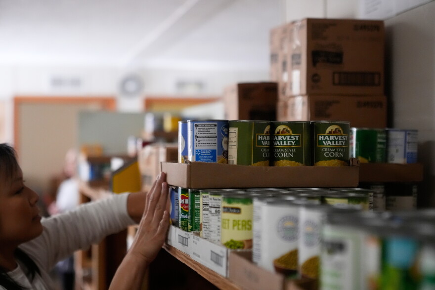 In this file photo, Volunteer Cathy Mileham sorts food at the Long Beach Community Food Pantry 