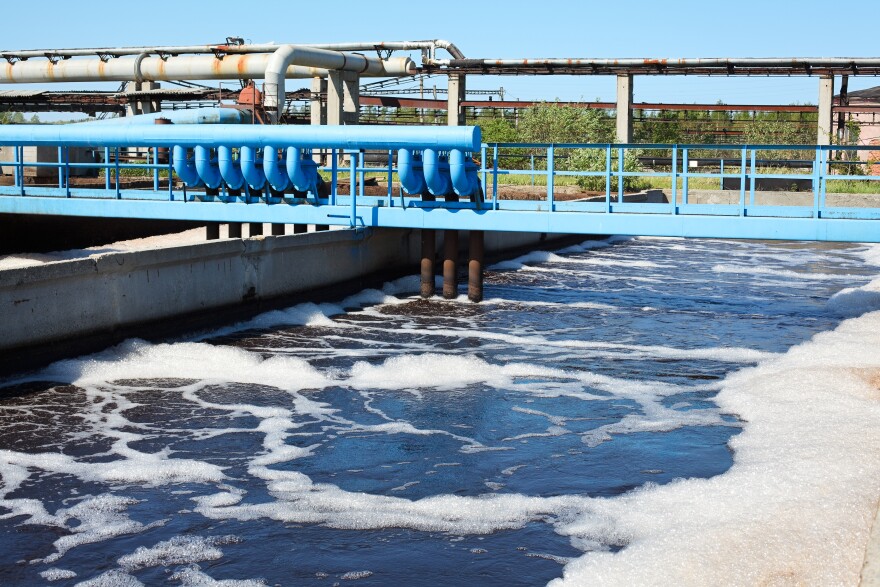 A water treatment plant with dirty sludge in a sedimentation tank.