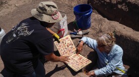 Matilde Torres, Indigenous cosmologist, explains El Tonalamatl de Aubin, a Tlaxcala codex book, to Texas Archeological Society Secretary Carol Macaulay-Jameson.