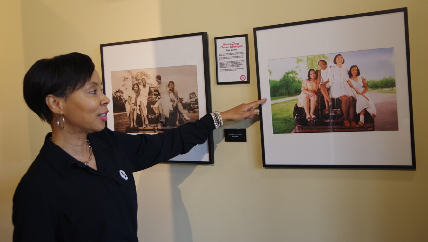 Merze Tate Founder Sonya Hollins gestures toward one of the many recreations of historic photos on display at the "Driving Into History: Black Women, Cars and Courage" exhibit at the Gilmore Car Museum.