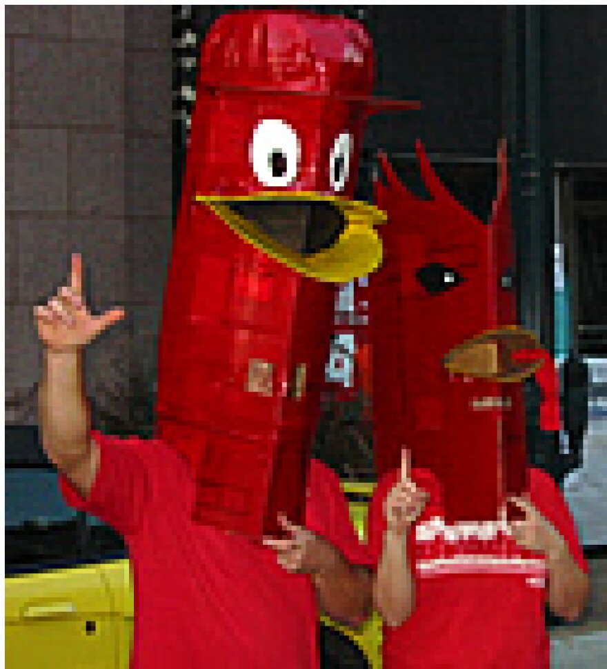 Cards fans don homemade redbird heads at Monday's pep rally on Washington Ave. (KWMU photo)