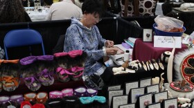 Barbara Apangalook, originally from Gambell, works on some beading at the Alaska Federation of Natives convention in Fairbanks on Friday, Oct. 18, 2019. (Casey Grove/Alaska Public Media photo)