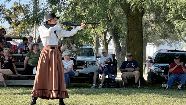 Alia Hunt aims her BB gun at a red balloon at the "Miss Annie Oakley" sharpshooting competition in Greenville.