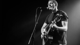 Matt Maeson plays his guitar as he sings onstage