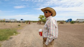 Javier Sanchez stands in his front yard in Lobo, Texas, as trucks delivering dirt to a new “man camp” for border wall construction workers drive past. “We lost all our tranquility,” he said.