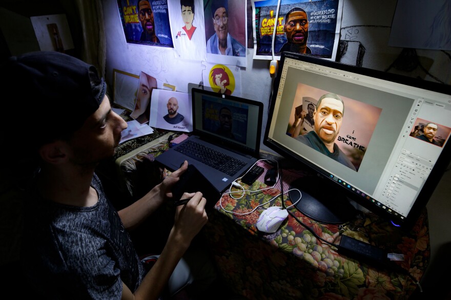 Palestinian digital artist Munes al-Salihi draws a portrait of George Floyd at his house in a refugee camp in the Gaza Strip on June 4.