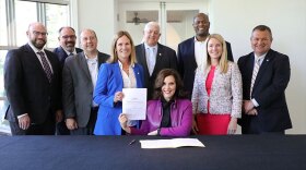 Gov. Gretchen Whitmer (center) and others gather after approving additional funding for the Strategic Outreach and Attraction Reserve (SOAR) Fund in 2022.