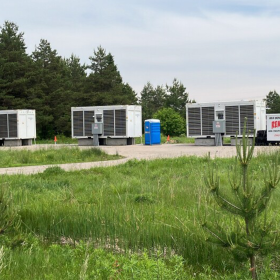 Three containerized data centers hum in Dafter Township, across the street from Lake Superior Academy, on June 19, 2025. Michael Carbonara's name appears on the permit application for this operation.