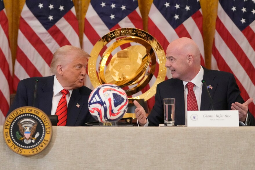 FILE - President Donald Trump and FIFA President Gianni Infantino talk during a FIFA task force meeting in the East Room of the White House, May 6, 2025, in Washington.