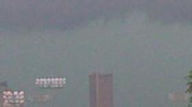 A heavy thunderstorm moves over the Tulsa skyline.