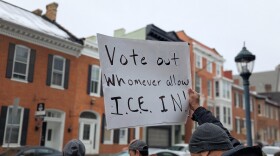 A protester holds up a sign that reads "Vote out whomever allow ICE in!" in Washington County, Md on February 10, 2026.