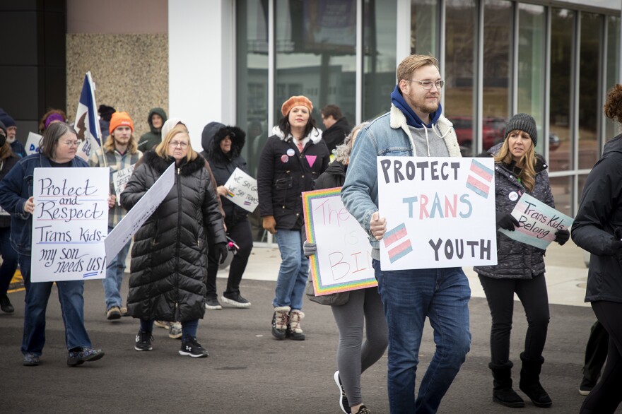 Protestors calling for LGBTQ rights stand outside a Pizza Ranch in Cedar Rapids, Iowa, where former Vice President Mike Pence is speaking on Feb. 15, 2023.