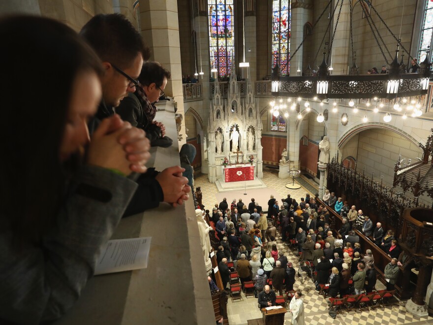 Worshippers gather at the Schlosskirche church in Wittenberg, Germany, where Martin Luther is thought to have nailed his "95 Theses" to the church's doors in 1517.