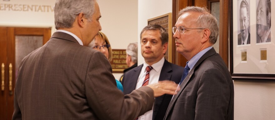 Senate President Pete Kelly and Sen. Anna MacKinnon meet with House majority leader Christ Tuck and House Speaker Bryce Edgmon just before adjourning the special session in Juneau on the night of July 15, 2017. (Photo by Jeremy Hsieh/KTOO)