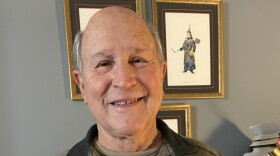 Joe Survant holding his book The Stone.
