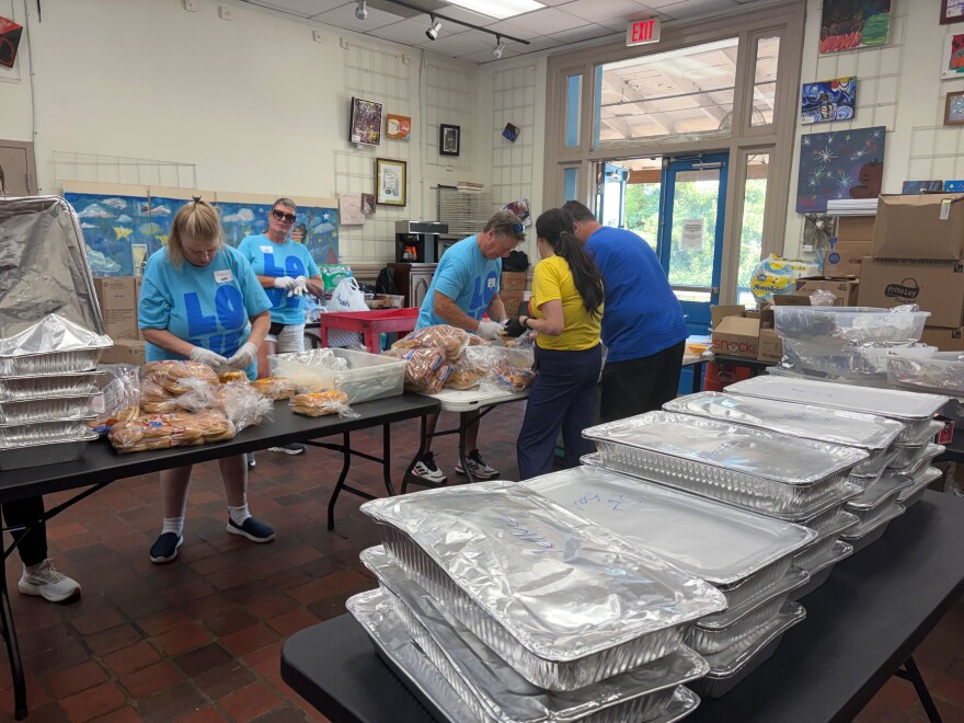 Volunteers prepare Friday's BBQ lunch at the Roof Above Day Services Center. 