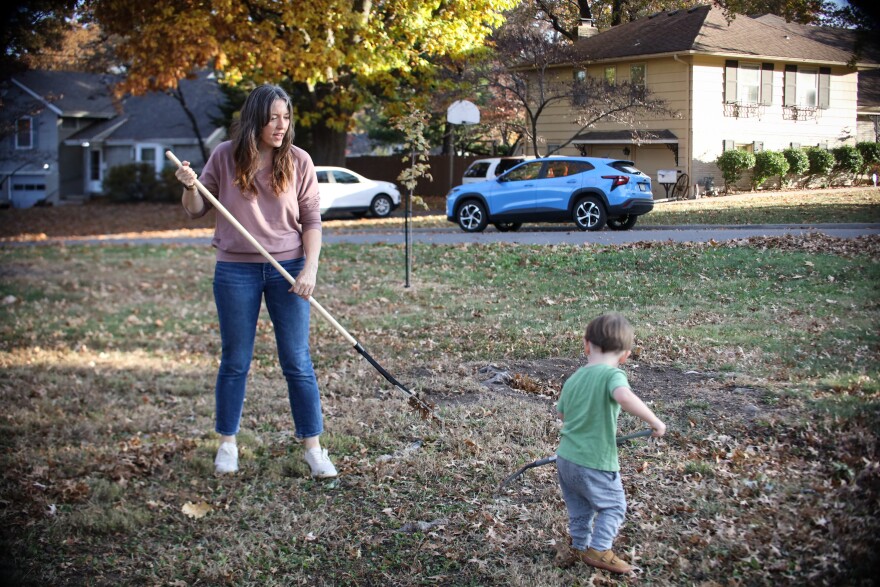 Annie Parsons and her son, River, rake leaves in their Roeland Park yard.