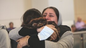 Latifa Sharifi (right) embraces her sister, Atefa Sharifi, near the International Arrival doors at the DFW Airport. Latifa and Atefa were separated from each other for more than a year.