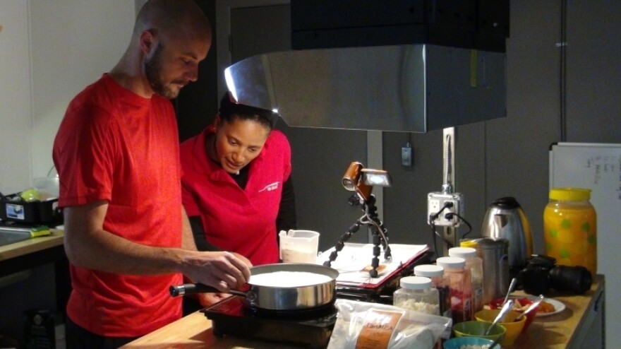 Crew members Sian Proctor and Angelo Vermeulen cook tsampa, a Tibetan food that consists of roasted flour.