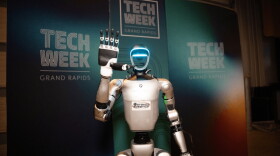 robot in front of logos for Tech Week Grand Rapids 2026