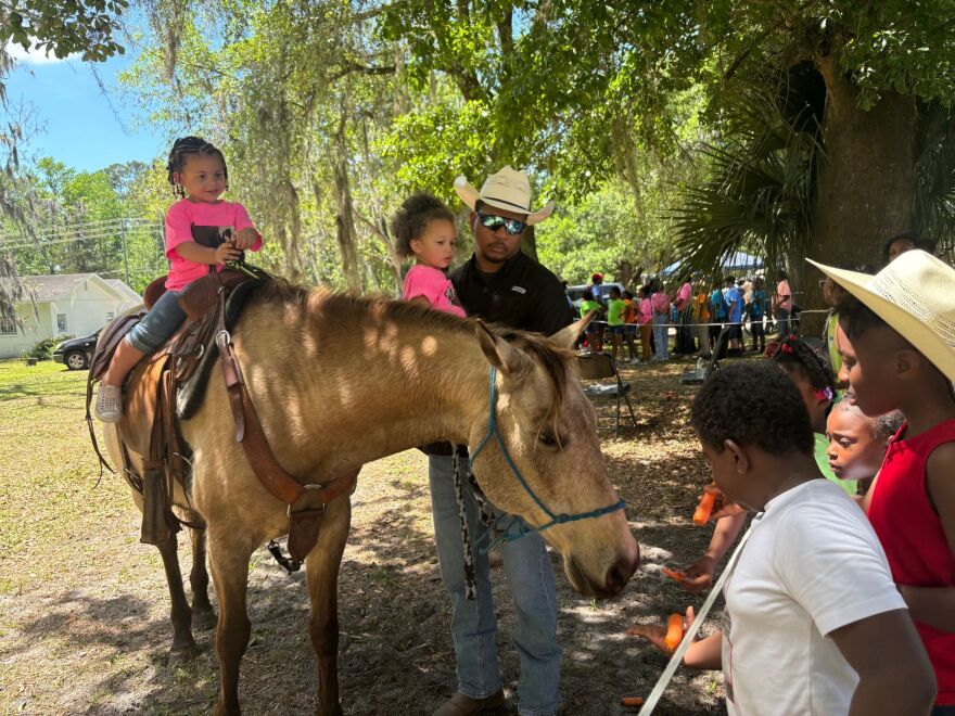 Local Alachua County cowboys educating children about the farming lifestyle at the Cotton Club Museum and Cultural Center. (Catalina Stoehr/WUFT News)