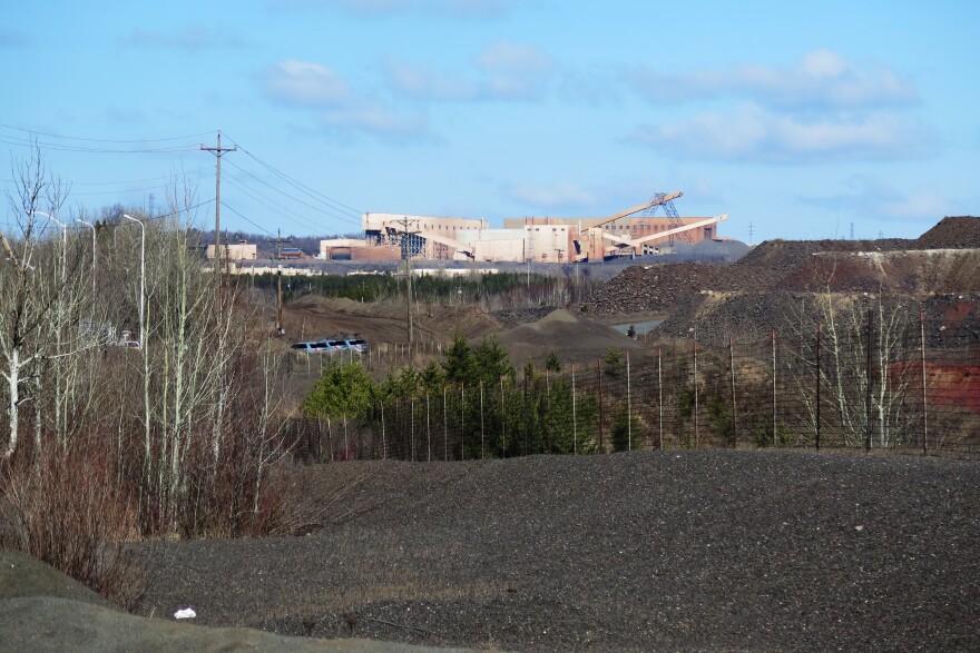 U.S. Steel's Minntac taconite mine and plant looms over the city of Virginia. The company plans to lay off around 700 employees on June 1.