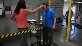 Employees at Kem Krest in Elkhart get temperature screenings upon entering the facility.