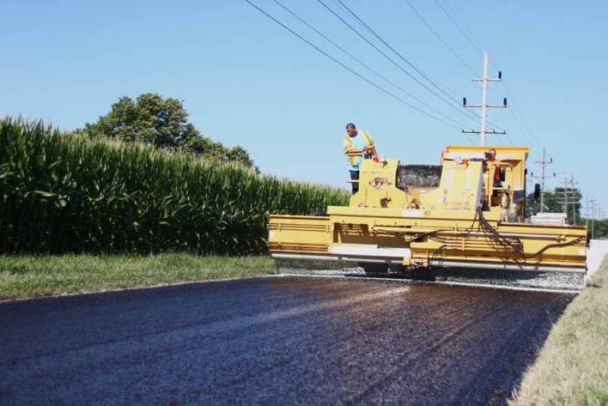 A Miami County highway crew chip-and-seals a road on July 30, 2026.
