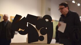 color photo of man looking at artwork inside Brandt-Roberts Galleries