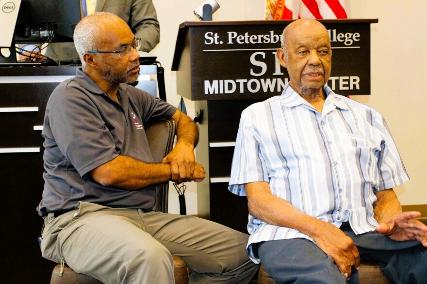 Two older Black men sitting side by side