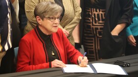 Democratic Gov. Laura Kelly signs the SOUL Family Permanency bill into law during a ceremonial event.