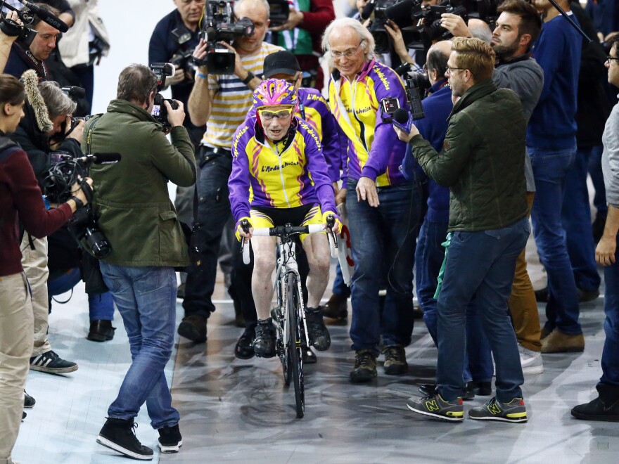 The centenarian was mobbed by members of the media at the velodrome on Wednesday.