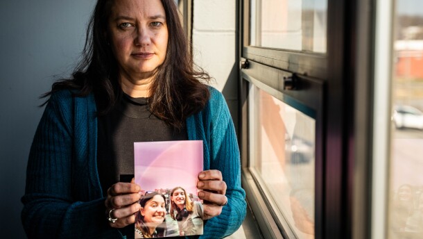 Jill Clements holds a photo of her daughter, Page. She finished high school early so she could move to Minnesota, where gender-affirming care is more accessible.