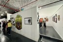 Visitors admiring artwork at the "Women Taking up Space" exhibit at Hangar Art Co. in Bloomington.