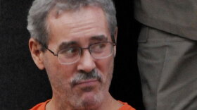 Financier Allen Stanford steps off a prison transport bus at the federal courthouse for a hearing Sept. 15.