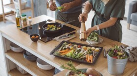 A couple preparing a colorful meal. (Getty Images)