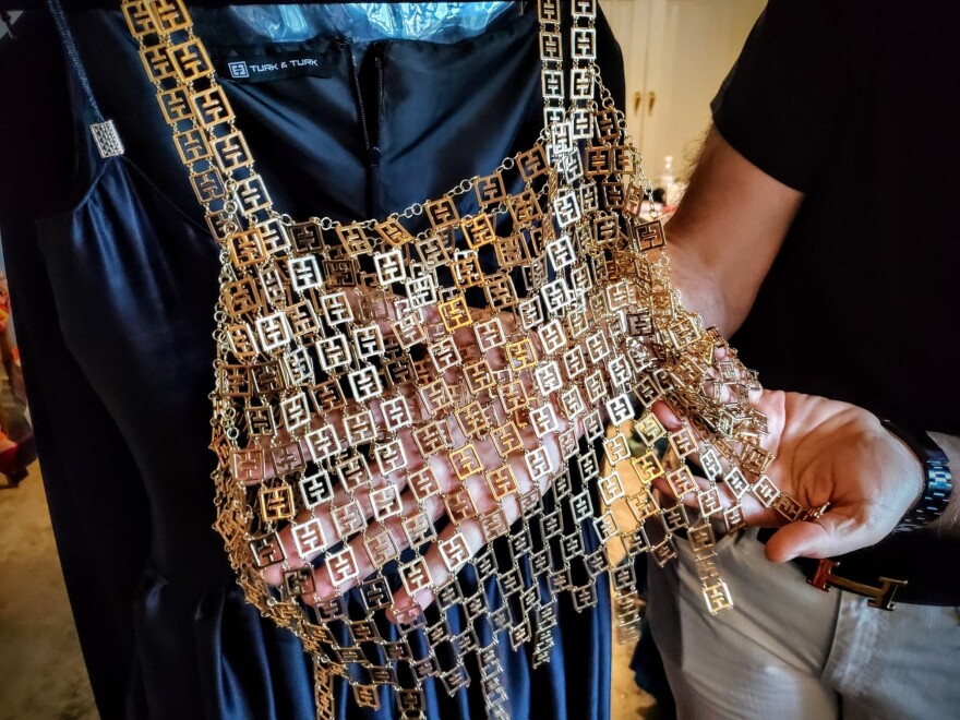 For this show, Rasit and Ilkay Turk are using materials like pennies to create necklaces, hundreds of gilded Turk & Turk logos to form camisoles, and silk dresses with their original sketches printed on them. “We don’t follow any step, any rule. Whatever comes into our life, we go for it," said Rasit.