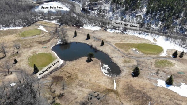 Overhead photo of a golf course with two bodies of water labeled