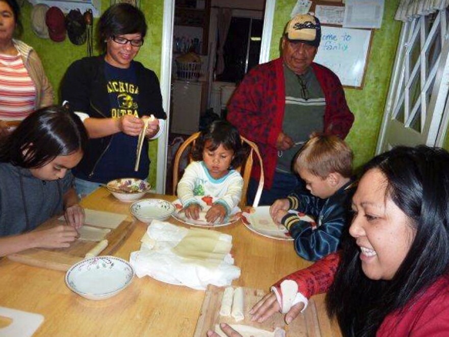 Melanie Vanderlipe Ramil is teaching the young people in her family how to make the traditional dish lumpia. Here, the family in 2009.