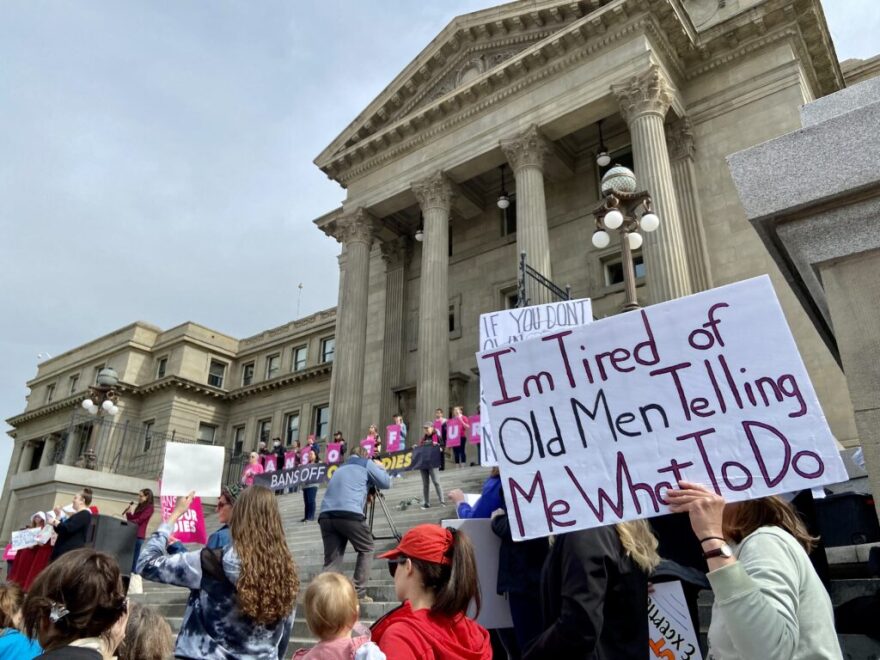 A woman holds up a sign at the Bans Off Our Bodies abortion rights rally at the Idaho Capitol Building in Boise as Idaho state Rep. Lauren Necochea, D-Boise, gives a speech. (Christina Lords/Idaho Capital Sun)