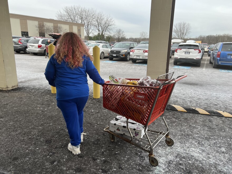 Vicki Stewart grabs a cart with bananas and other food staples to distribute to food pantry patrons at Brookside Church in Chillicothe.